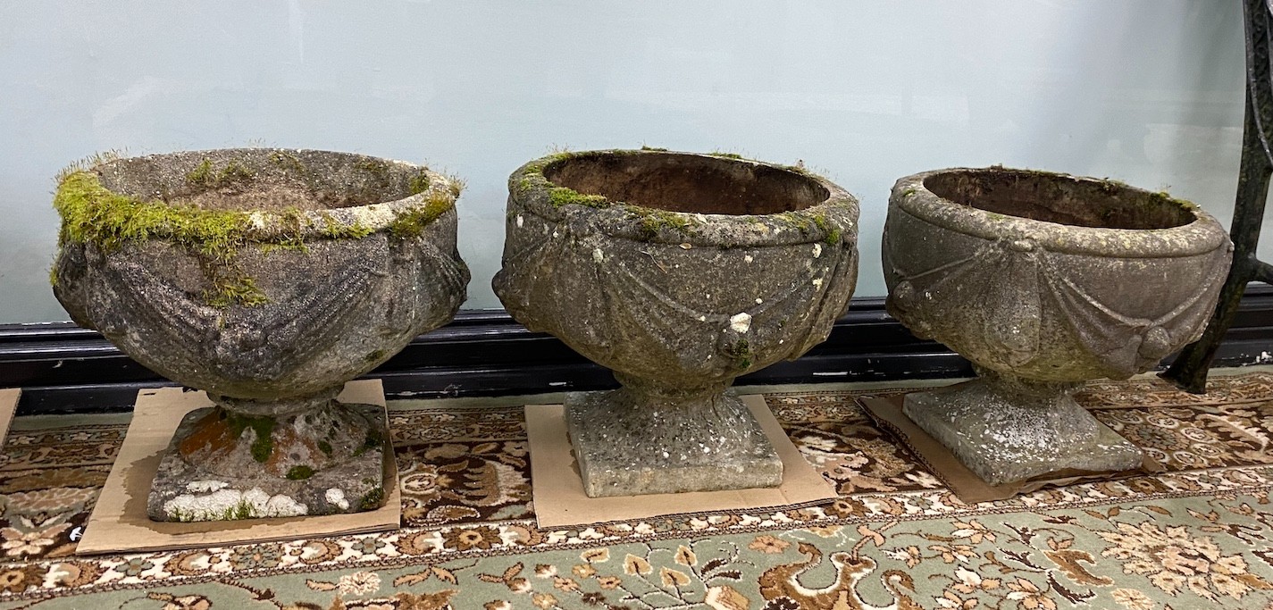 Two pairs of circular reconstituted stone garden planters, larger diameter 39cm, height 33cm